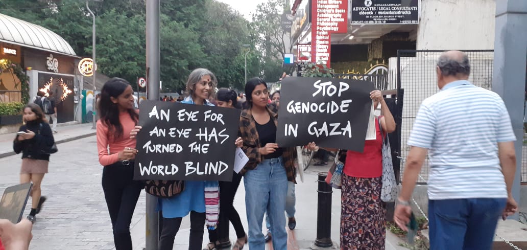 Placard holding members at the solidarity event in Bengaluru