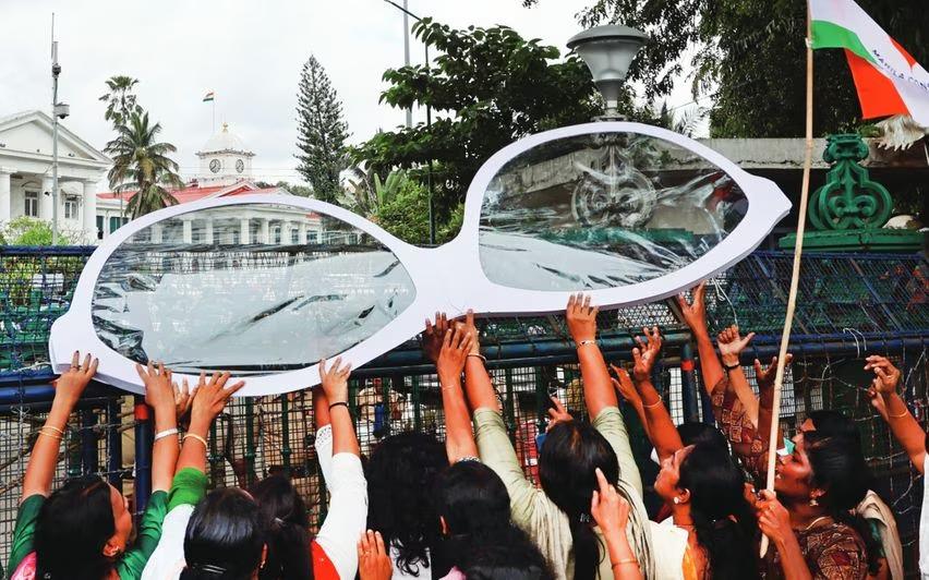 MahilaCongress Mahila Congress workers protesting the splurge on reading glasses out the Secretariat. (Supplied)