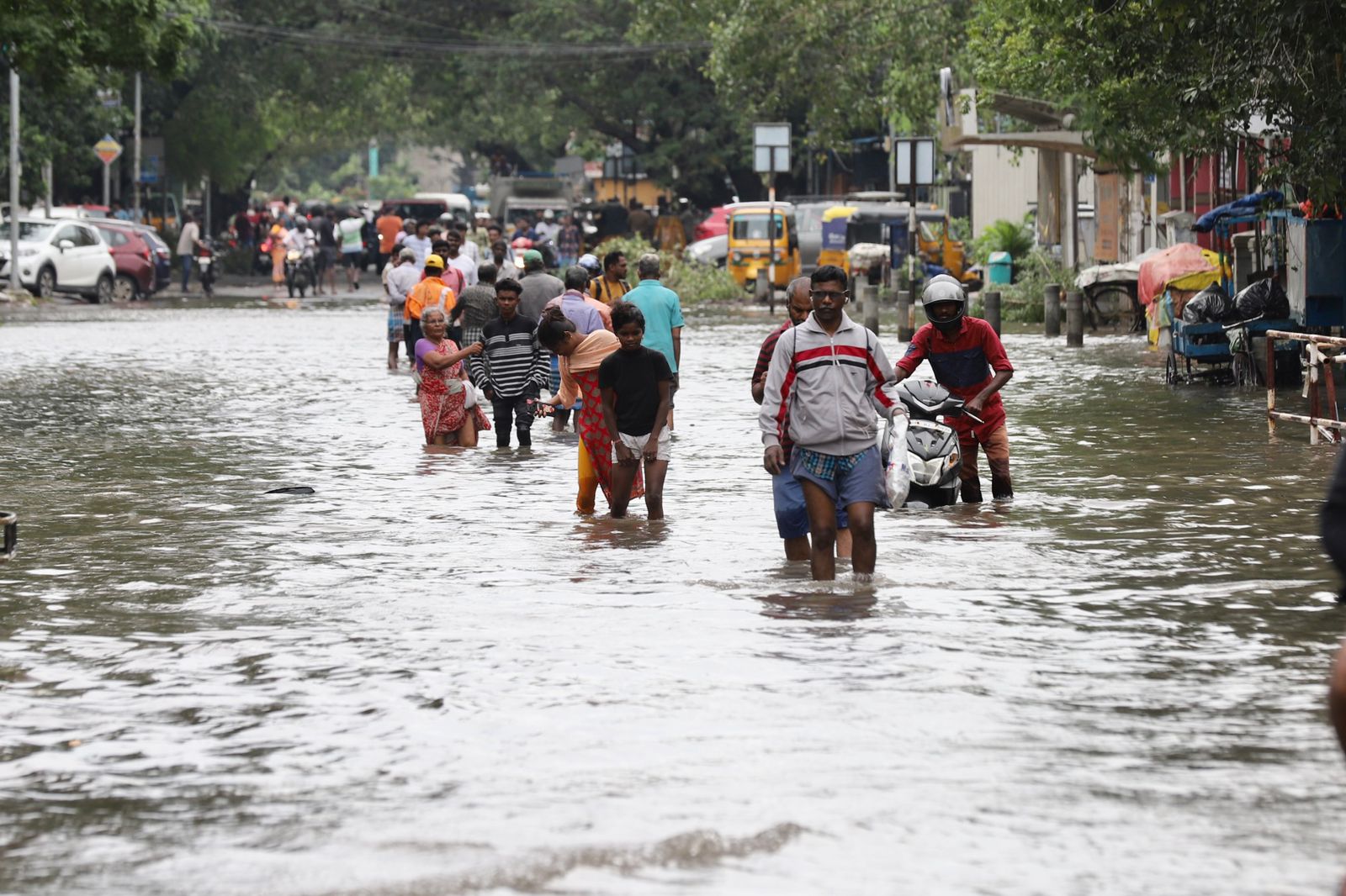 People walking through the flooded roads in Chennai. People walking through the flooded roads in Chennai.