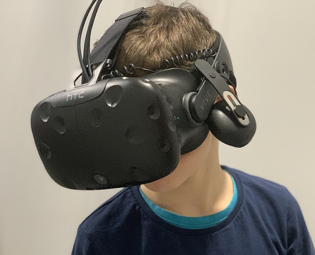 The gamer experiences the virtual world, interacting with it as if the individual is there in person. (Creative Commons)