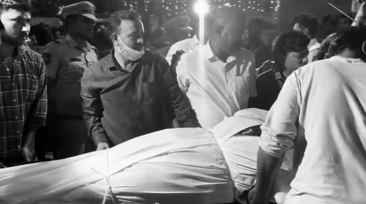 The body of the deceased being carried to a hospital for postmortem. (Supplied)