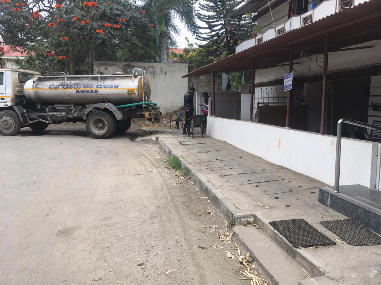 BWSSB tanker supplying water to a building