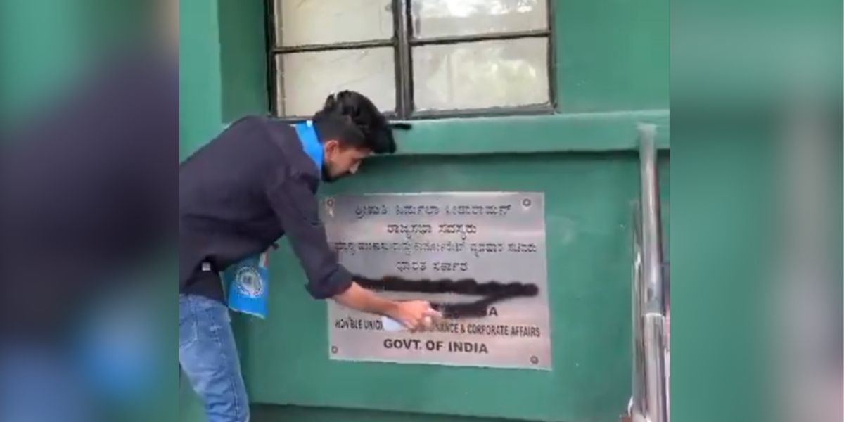 NSUI activists smear black paint on FM Nirmala Sitharaman’s nameplate at her Karnataka office. (Screengrab)