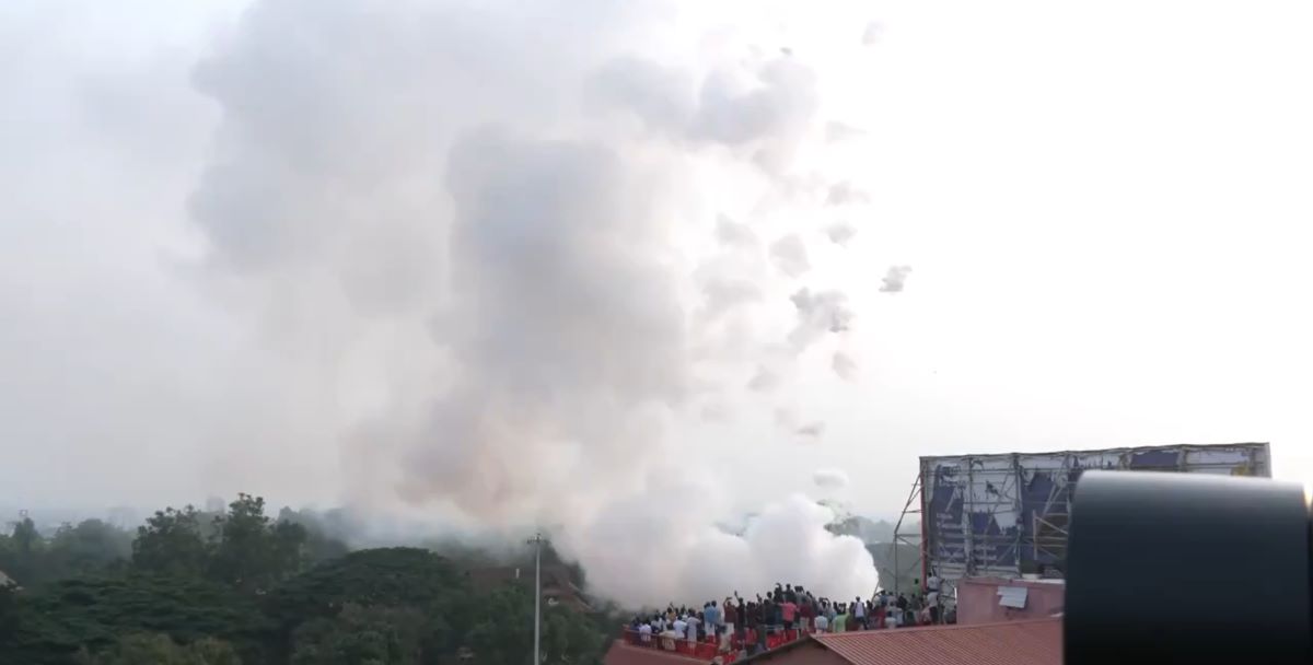 People witnessing the Thrissur Pooram fireworks in daylight People witnessing the Thrissur Pooram fireworks in daylight