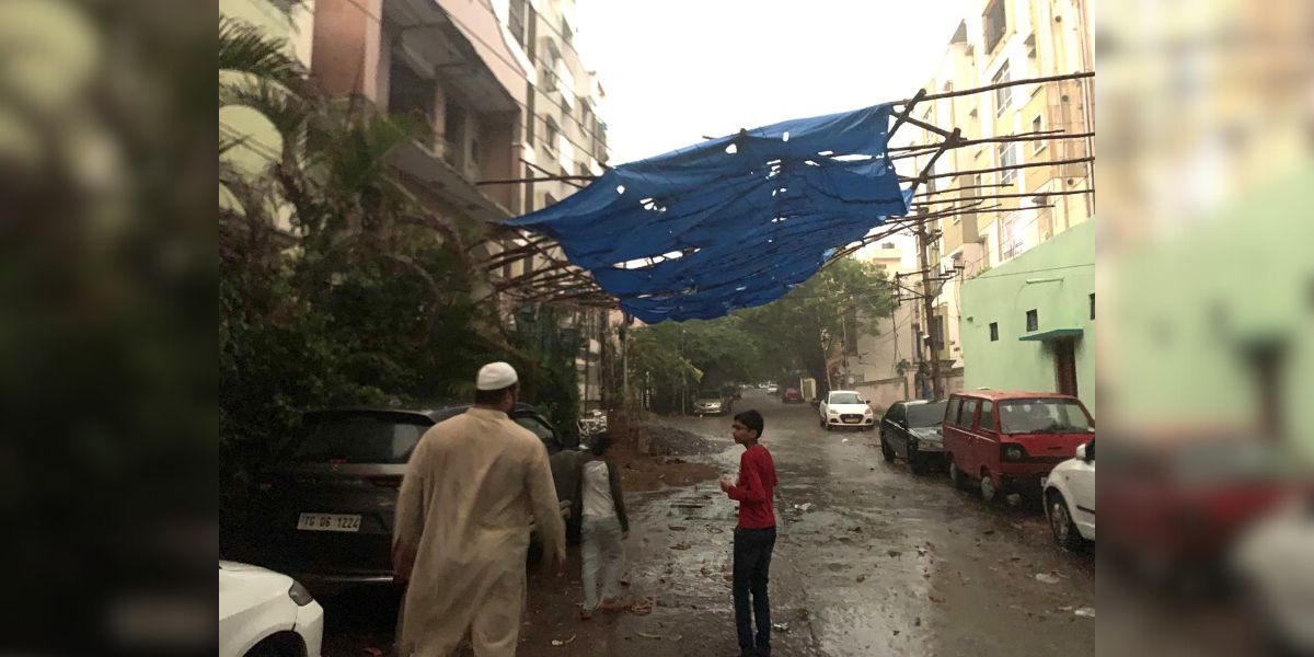 Hyderabad rain People venture out in the rain in Hyderabad on Tuesday, 7 May, 2024.