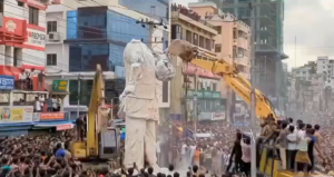 Protestors destroying the statue of Sheikh Mujibur Rahman.