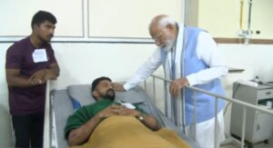 Prime Minister Narendra Modi interacting with an injured survivor at WIMS Hospital.