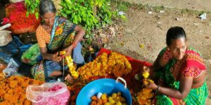 Poonkodi and her mother-in-law making marigold garlands.
