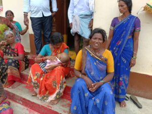 Sreelatha (centre, holding the baby) sitting with her mother-in-law, Susheela (Sumit Jha/South First).