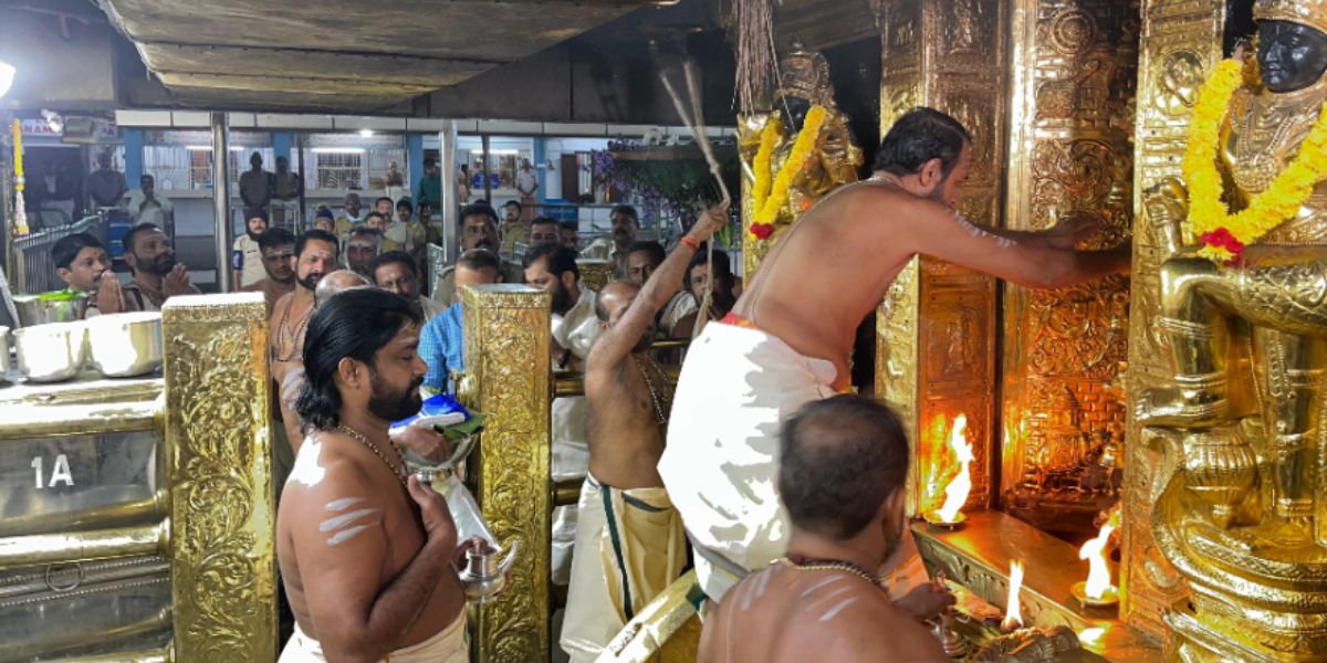 A priest opening the sanctum sanctorum of the Sabarimala Temple, A priest opening the sanctum sanctorum of the Sabarimala Temple.
