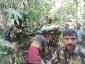 Police commandos and others shift Radha's body. (Supplied)