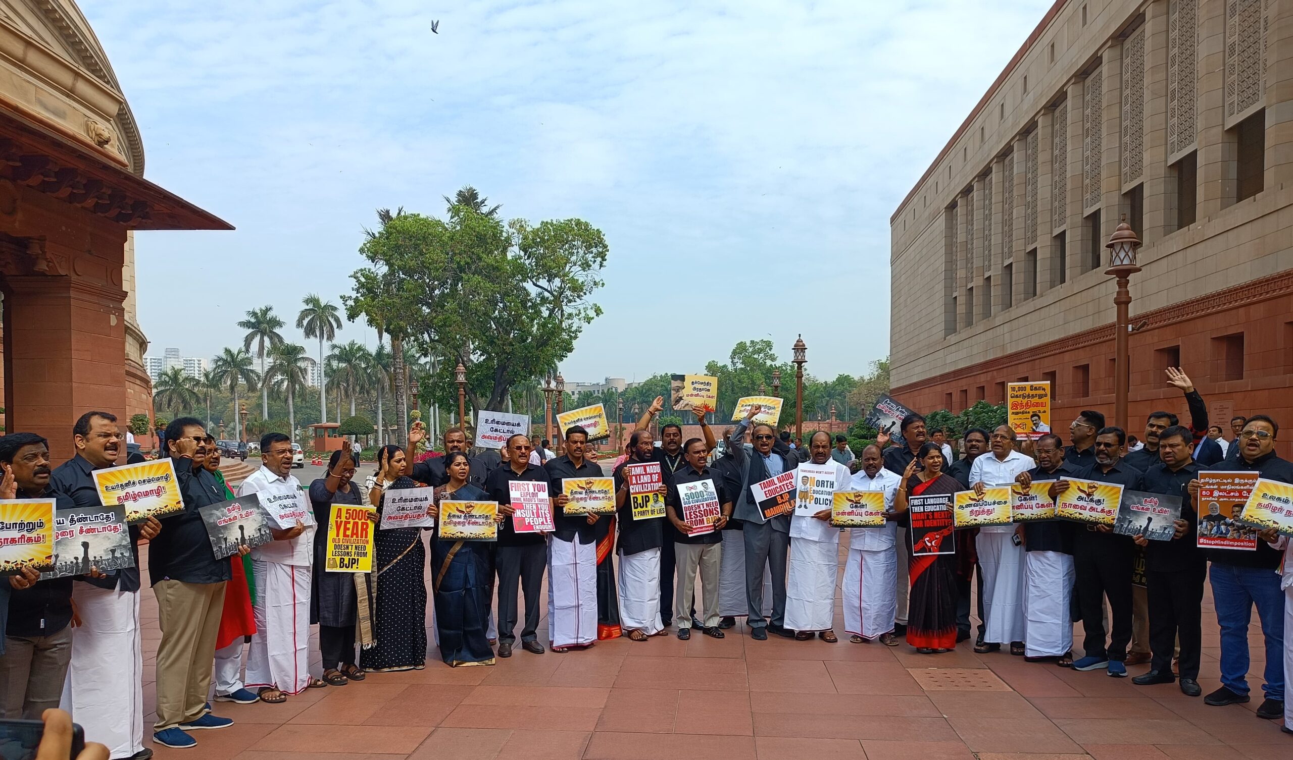 DMK MPs protesting against Union Minister Dharmendra Pradhan outside Parliament on Tuesday, 11 March.