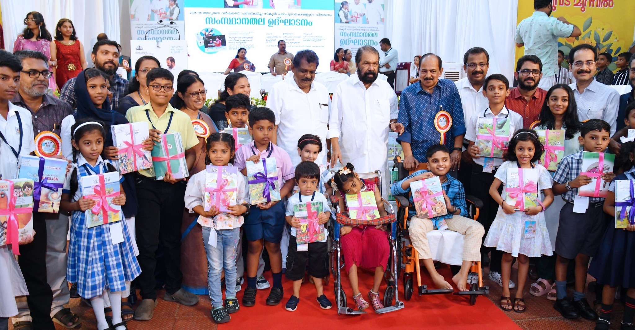 Children with textbooks for upcoming academic year.