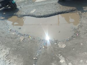 Potholes pose a danger to motorists and pedestrians.