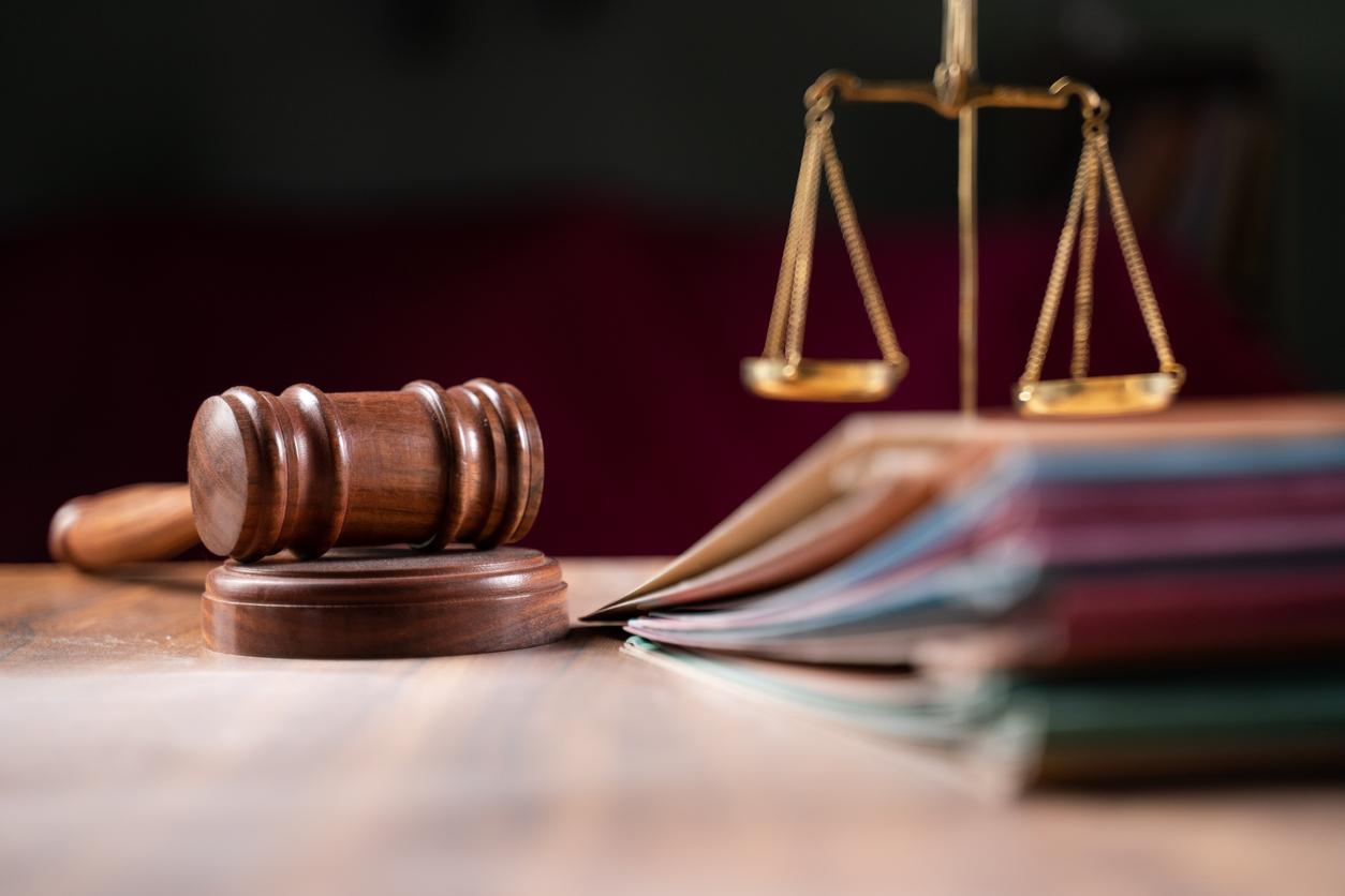 focus on hammer, group of files on judge table covered with dust – concept of pending old cases or work at judicial court Judgement