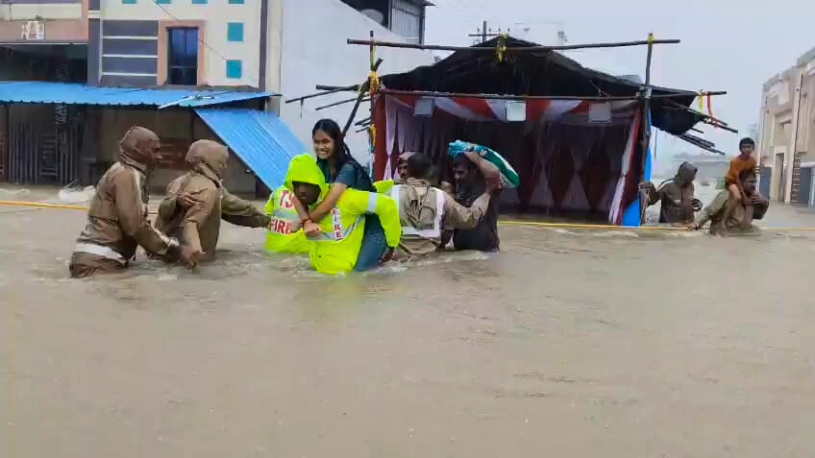 August-2025-1 A student being carried across the water in Medak