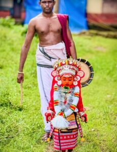 Prayan, as Vedan Theyyam, on his way to visit homes.