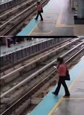 A visual from a surveillance camera shows the woman — engrossed in her mobile phone — seconds before falling onto the railroad. 