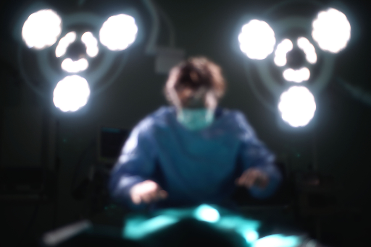 Blur Surgeon in Operation room under surgery lights Illegal kidney transplant.