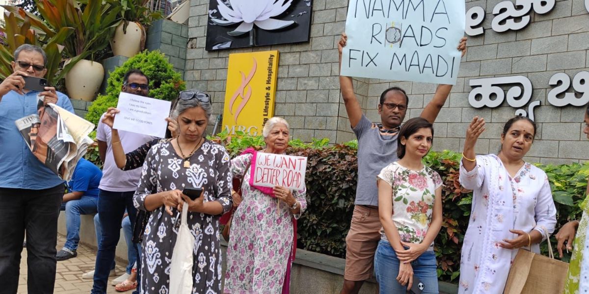 Residents protesting along Varthur Road against bad road conditions.