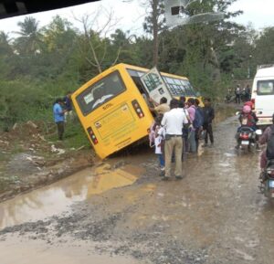The bus driver apparently did not gauge the depth of the water-filled pothole.