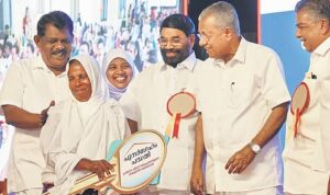 CM Pinarayi Vijayan handing over keys to fisherfolk flats under the ‘Punargeham’ project last August.