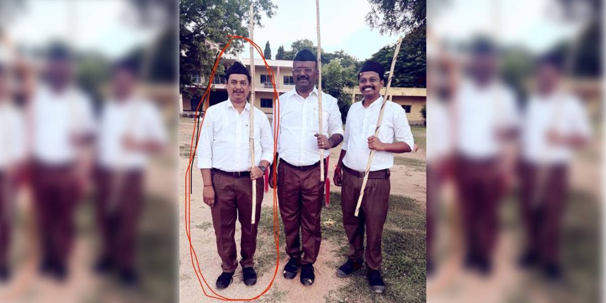 Praveen Kumar (circled) was suspended on Friday, 17 October, after a picture showed the official in an RSS uniform, and holding a stick alongside RSS cadre. 