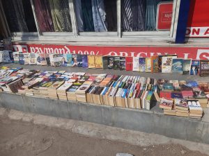 Books lying on the street on a Suanday in December at Abids