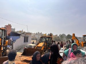 Excavators demolishing the houses.