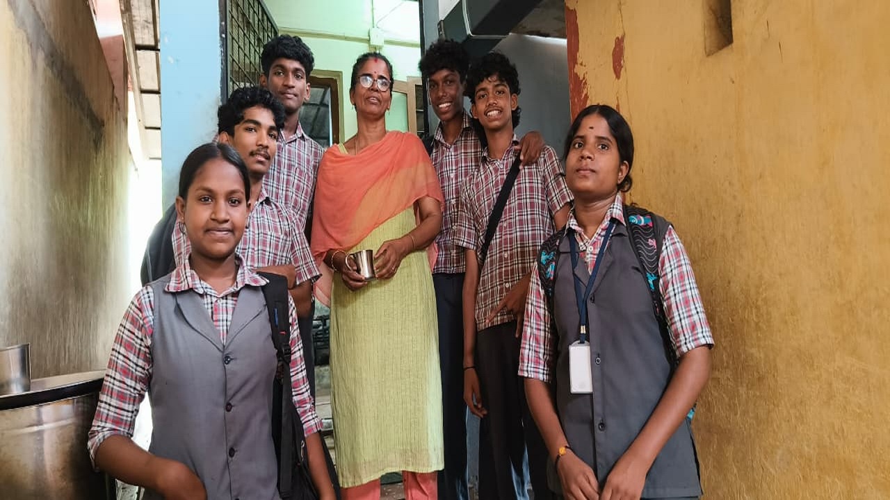 Students at SNDP HSS, Aluva, with their school cook, Bindu.