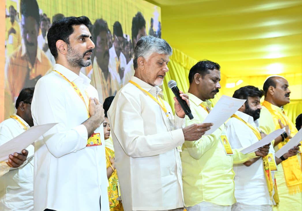 N Chandrababu Naidu administering the oath of office to Nara Lokesh and other TDP office bearers.