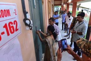 An official opening a strong room in Kerala.