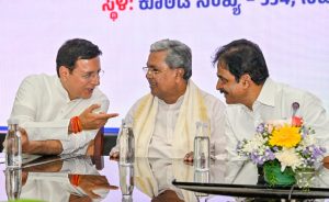 Karnataka's caretaker Chief Minister Siddaramaiah flanked by AICC General Secretaries Randeep Singh Surjewala (L) and KC Venugopal at the CLP meeting.