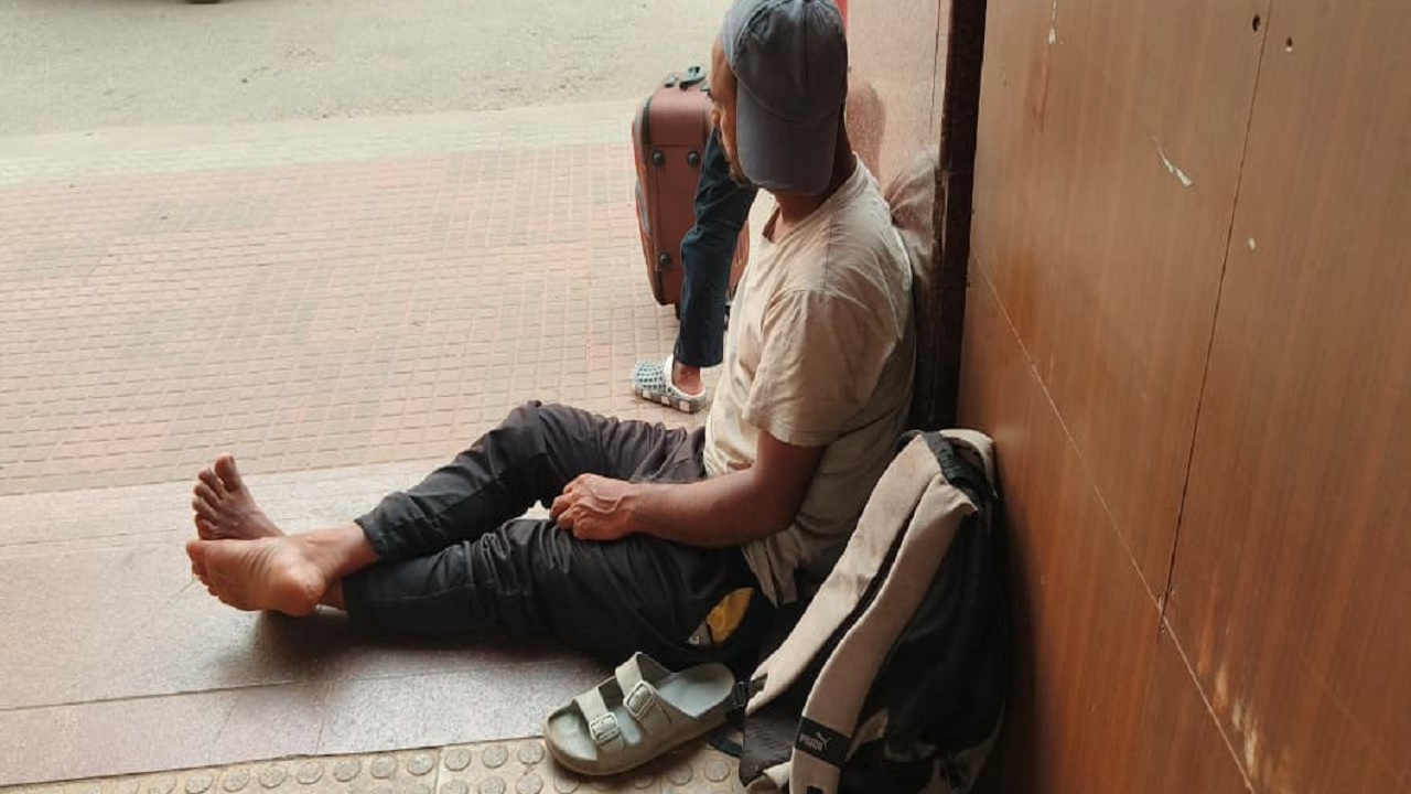 A migrant worker sitting at Aluva railway station.