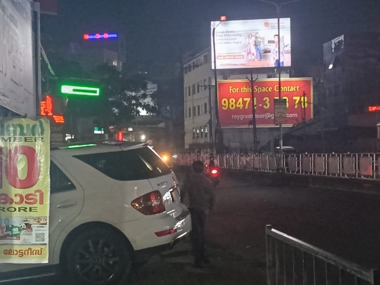 Kochi, 17 July: A pedestrian steps onto the road as a swanky car prevents safe movement on the footpath.