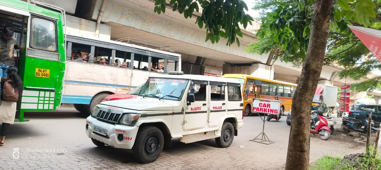 Ernakulam, 6 July: A police vehicle is parked on the footpath at a bus stop near Aluva Market. Law enforcers themselves are breaking the law!