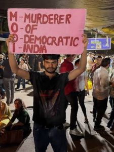 A protester holding a placard targeting Prime Minister Narendra Modi during the CJP protest. (Instagram)