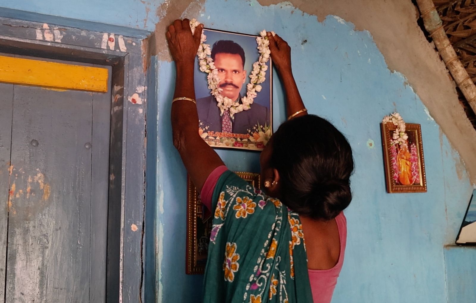Rani garlanding a photograph of her late husband Deiva Sagayam.
