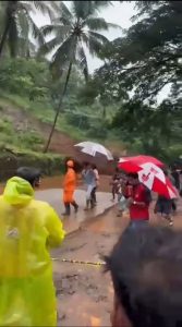 People scramble for safety as a landslip sends down debris at Karuvarakundu.
