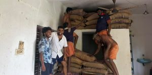 People storing food items for relief camps.