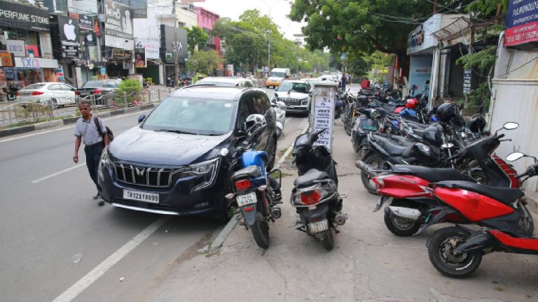 Vehicles parked on the footpath in front of RBL Bank on 4th Avenue Road in Chennai's Anna Nagar force pedestrians onto the road. (Sunish P Surendran)