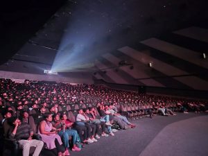 Moviegoers soaking in the big-screen experience at a multiplex courtesy - Ariesplex SL Cinemas 