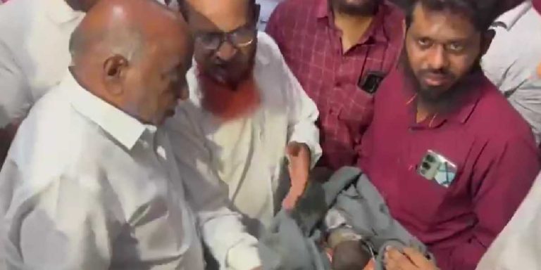 Fasil holding his daughter.