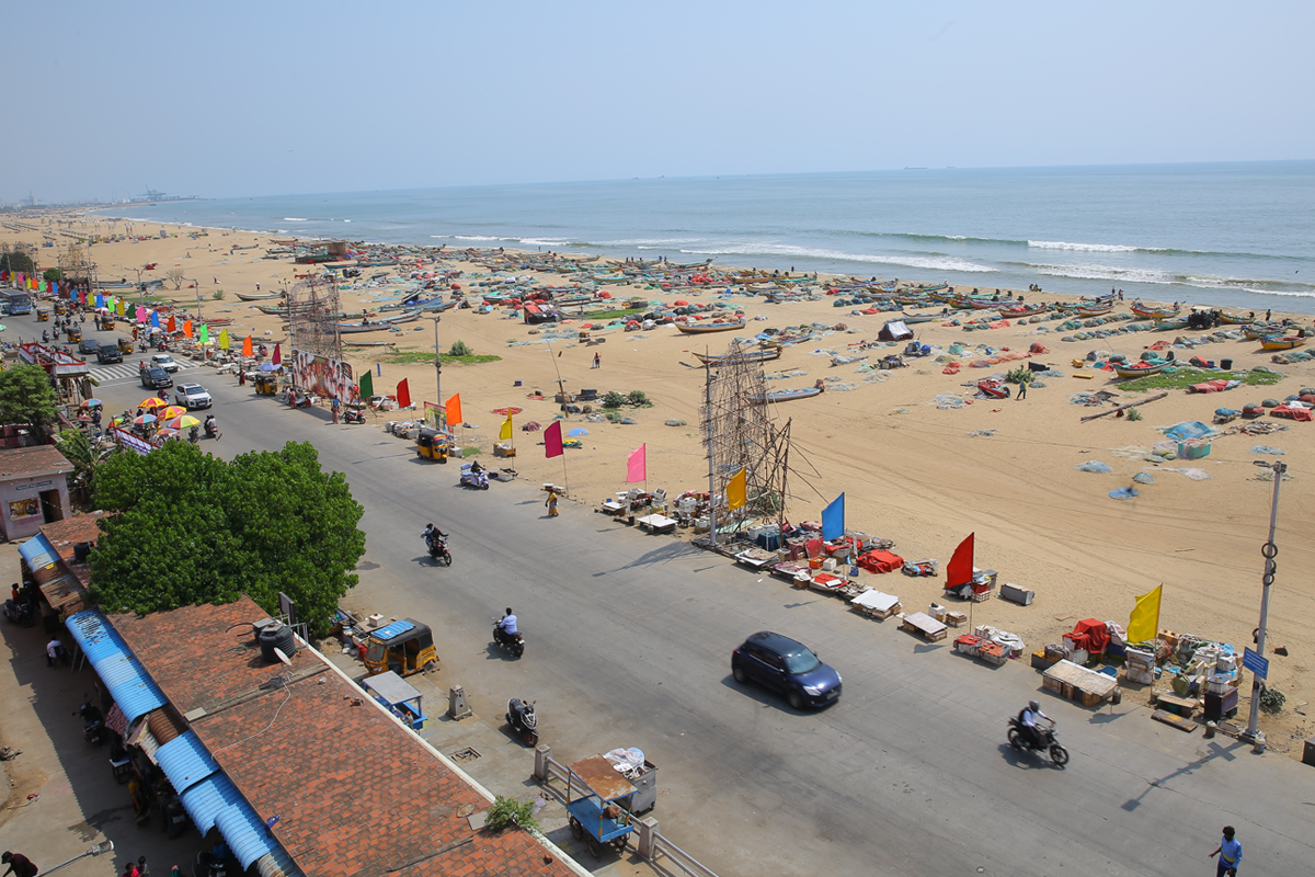 Fishing boats, nets and equipment spread across the sandy beachfront at Pattinapakkam.