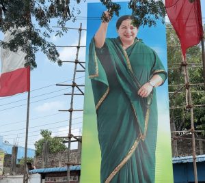 Large cut-out of former Tamil Nadu Chief Minister J Jayalalithaa displayed beside AIADMK flags on a campaign road in Maduranthakam.