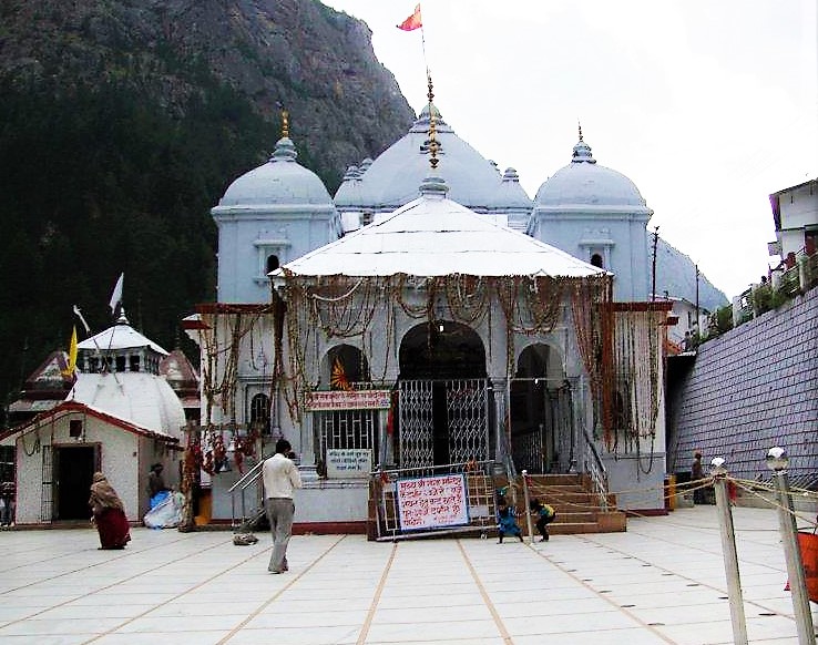 Man walking toward gangotri temple and kids are playing in the gangotri temple premis