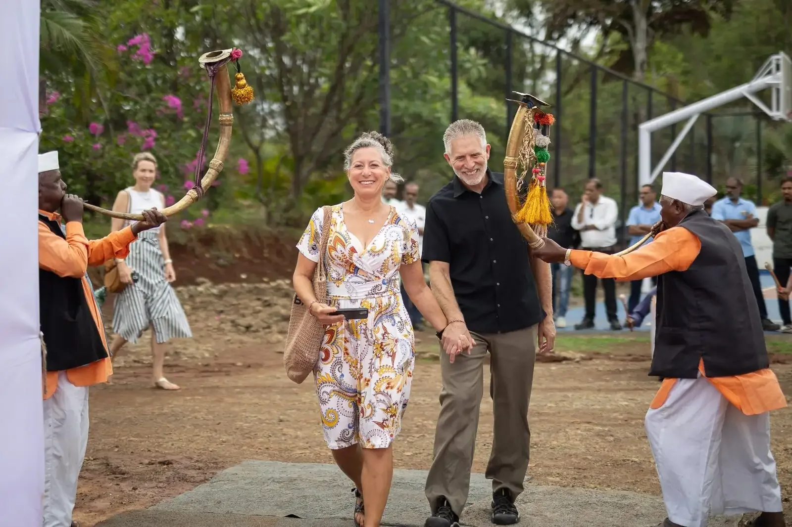 Parents welcomed onto campus through a traditional arch by villagers