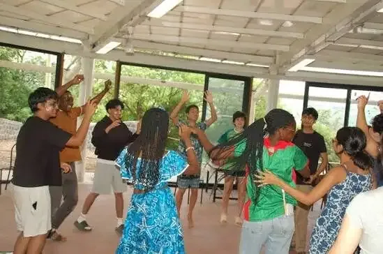 Students dancing together in a campus hall