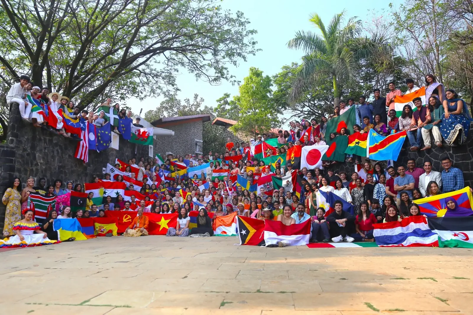Students gathered with the flags of seventy-plus nations