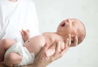 a lady holding a newborn baby